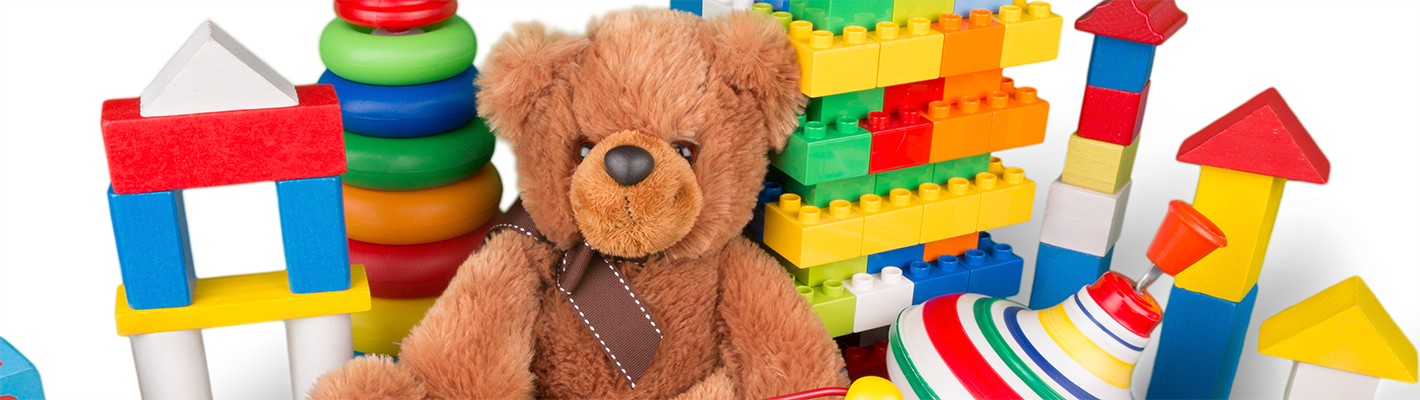 baby bear in front of block and other toys